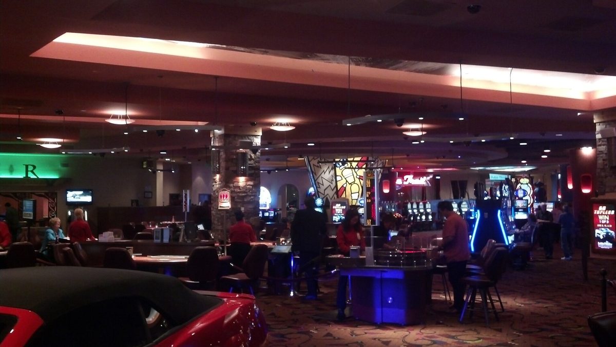The gaming floor of a casino, slot machines along the far wall