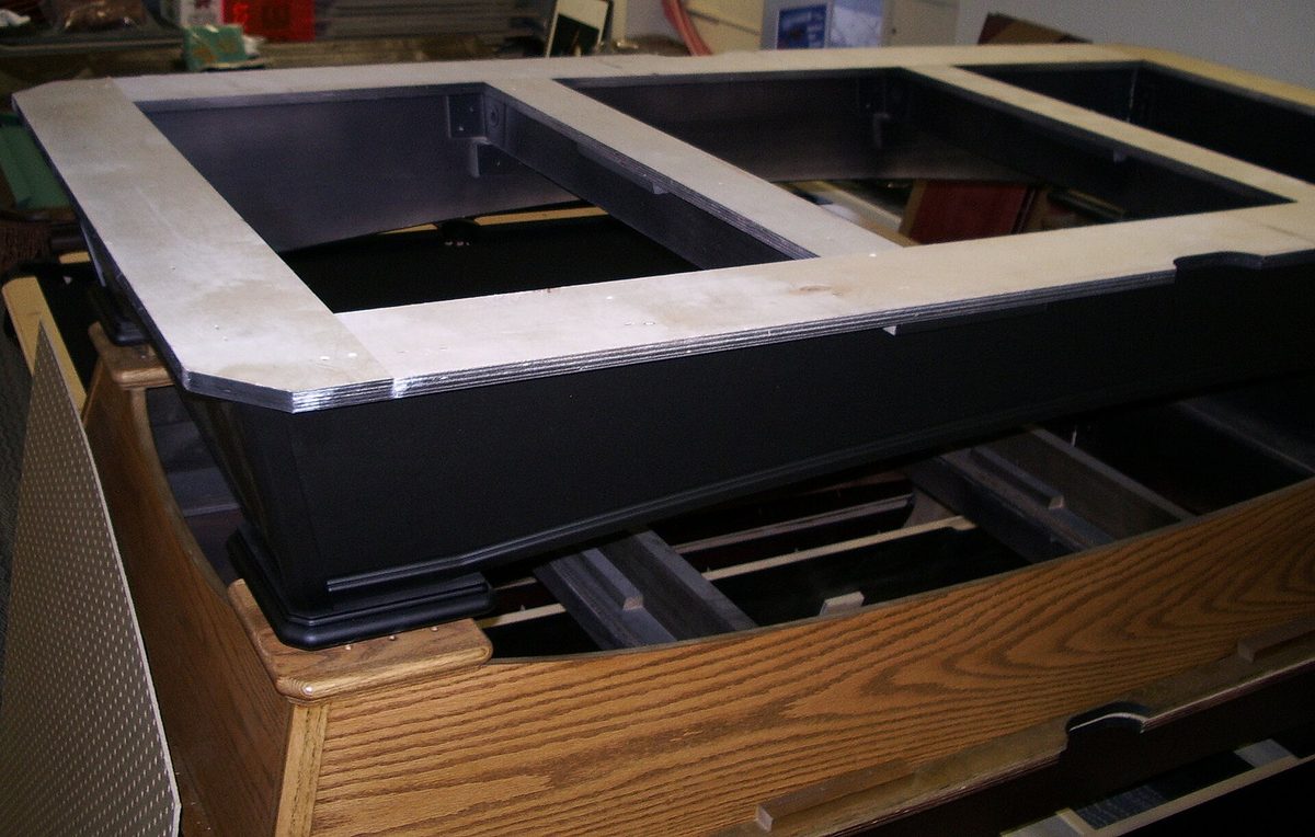 Pool table frames stacked, the support struts for the bed slates in view