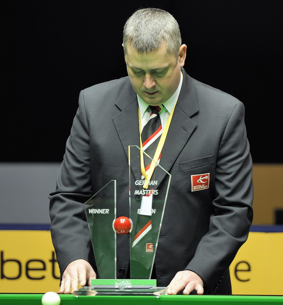 An official sets the German Masters winner’s trophy down on the baize