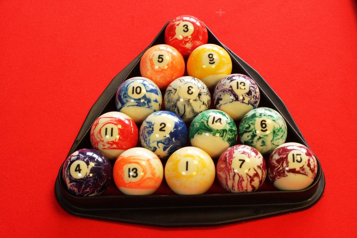 A full set of object balls gathered inside the triangle