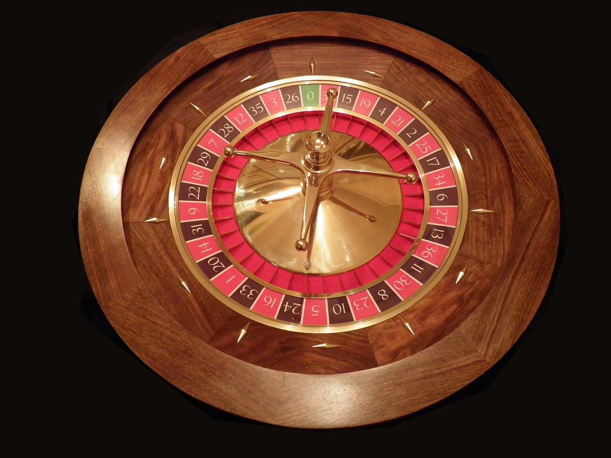 A roulette wheel off the table, the numbered rim and spindle in view