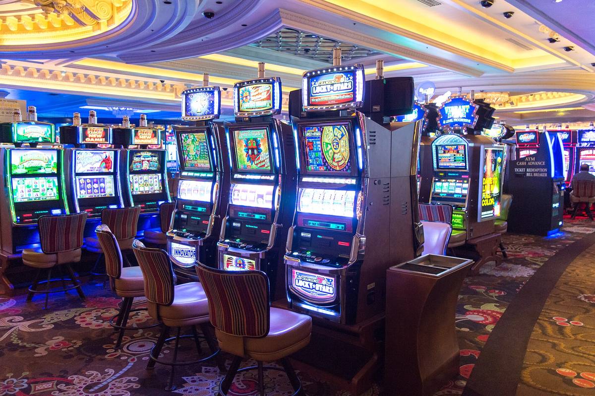 A row of slot machines on the floor of a Las Vegas hotel casino